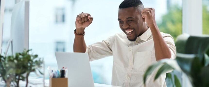 Man celebrating at his desk