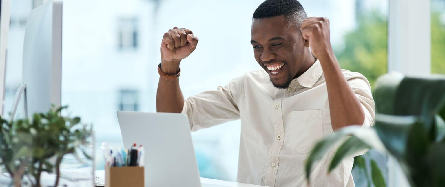 Man celebrating at his desk