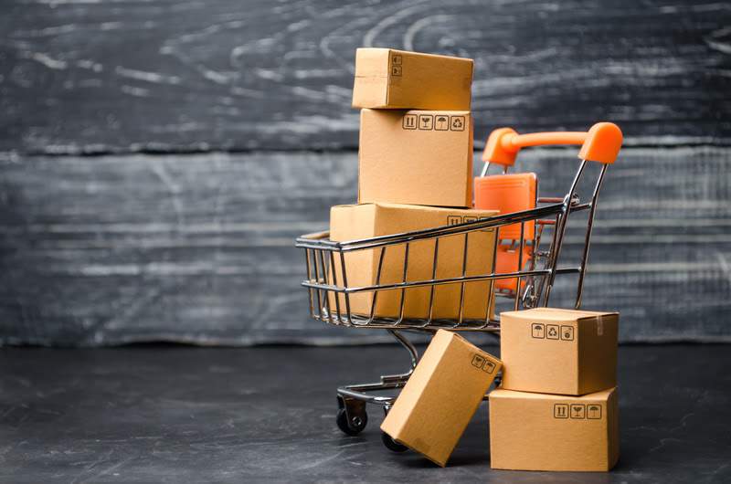 shopping cart filled with brown boxes