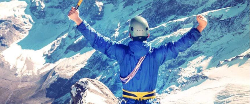 guy cheering once he reached the top of the mountain