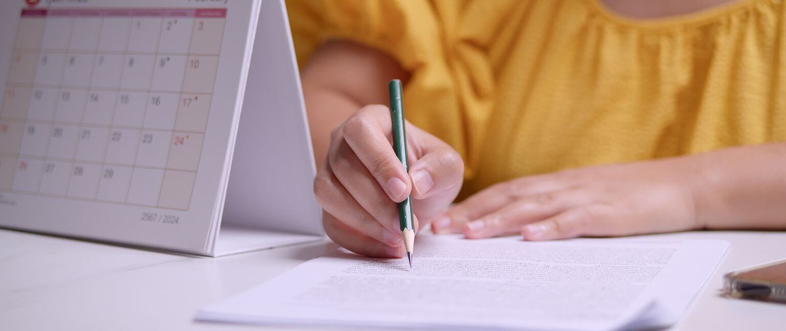 Woman writing on a notepad