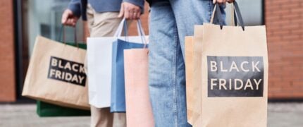 People holding black friday shopping bags