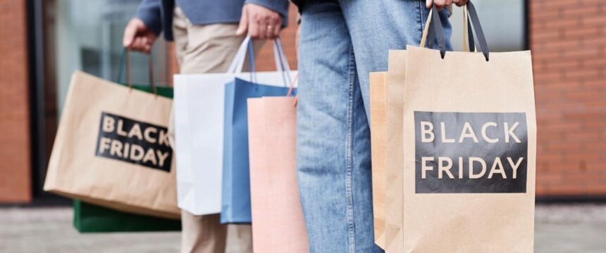 People holding black friday shopping bags