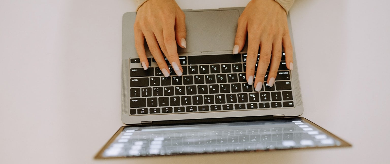 aerial view of woman typing on computer