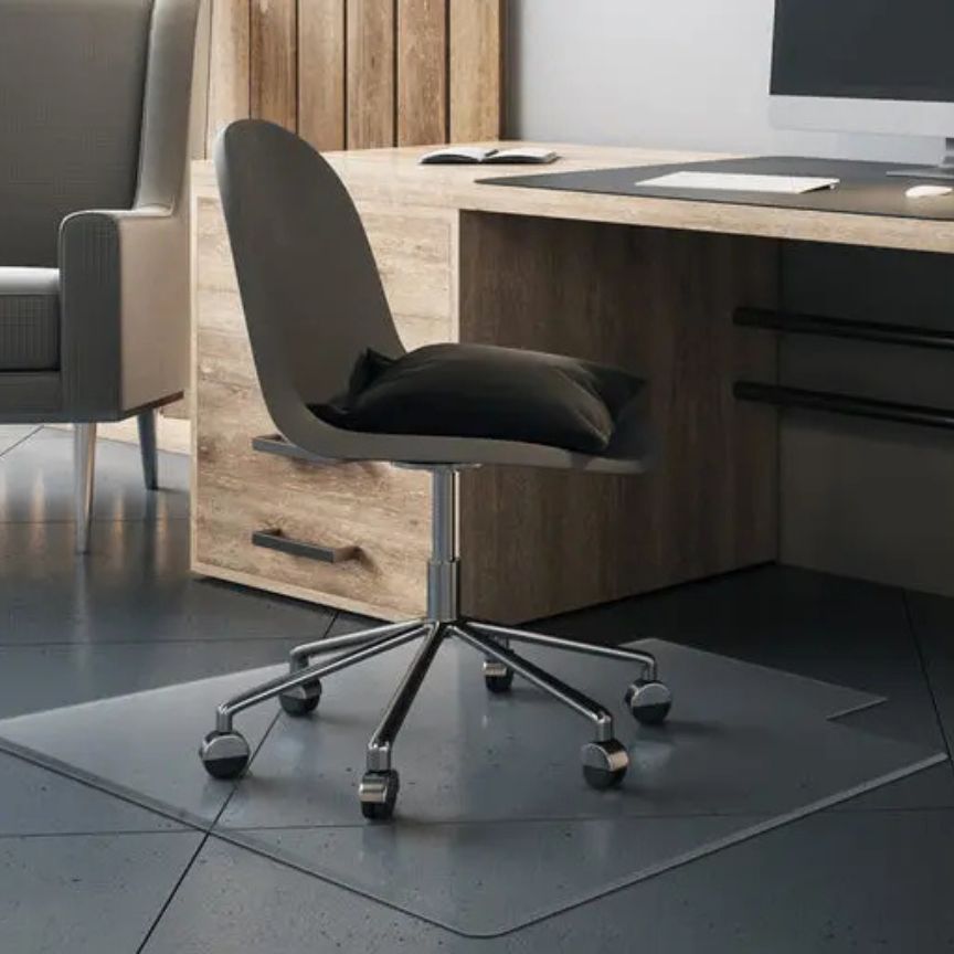 black desk chair on glass mat